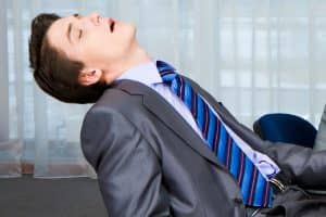 Sleeping At Work Photo of displeased businesspeople looking sternly at snoring man at presentation